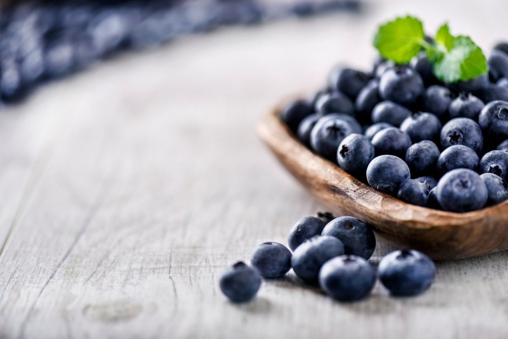 Wooden bowl of blueberries, part of Face Fit's Skin Food