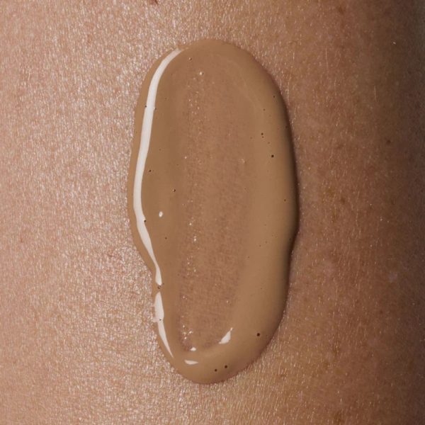a close up of the tinted liquid on a person's skin
