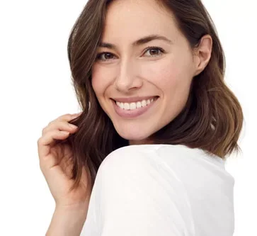 Woman with beautiful skin looking over shoulder and smiling