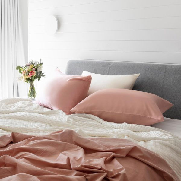 lunalux blush pink pillowcase on bedding in lifestyle shot