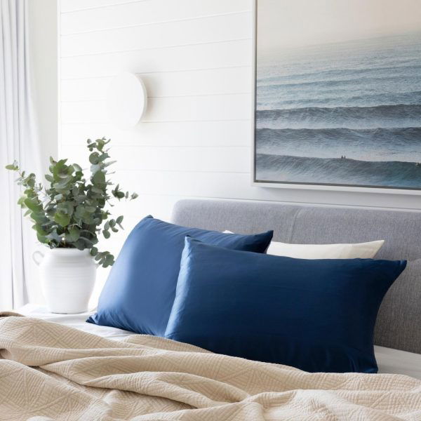bed made up with lunalux midnight blue silk pillowcase in lifestyle shot