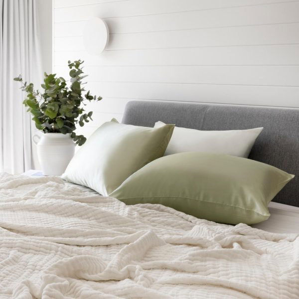 lifestyle shot with bed made up with lunalux sage green pillows