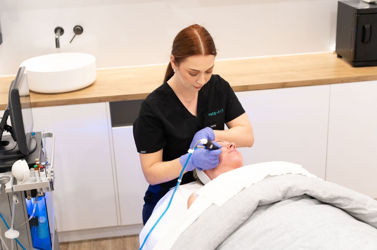 Dermal therapist conducting a skin treatment on woman patient